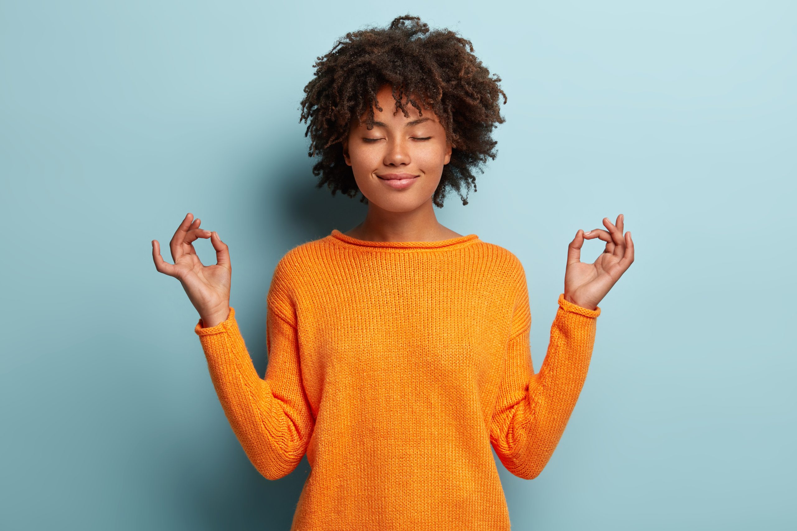 Mindful,Peaceful,Afro,American,Woman,Meditates,Indoor,,Keeps,Hands,In